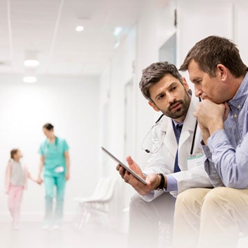 A man and his son discussing quiting with their doctor